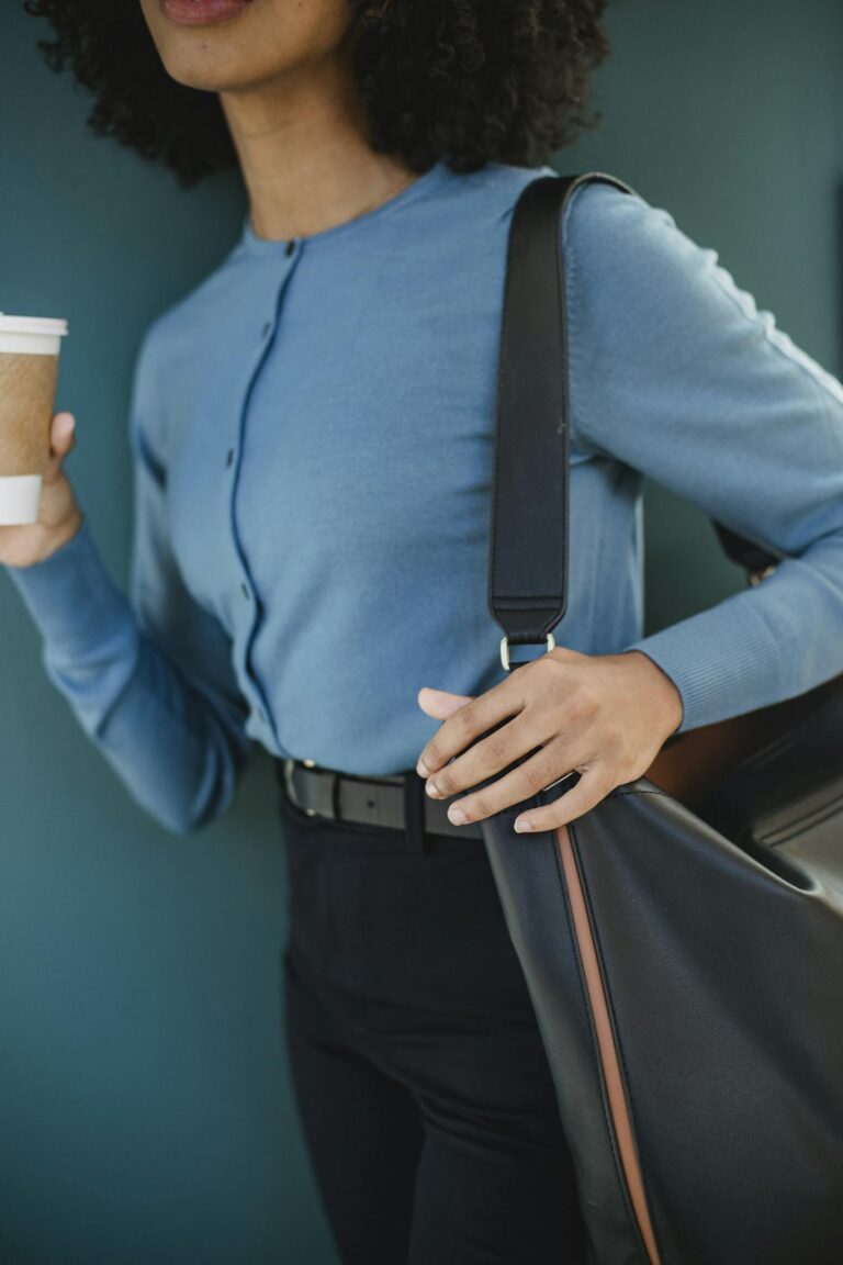 A Woman with a Bag and a Coffee Cup