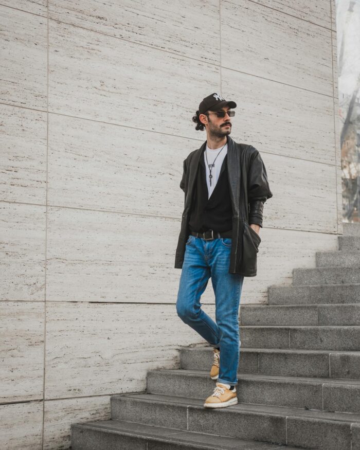 Man in Leather Jacket and Jeans Coming Down Stairs