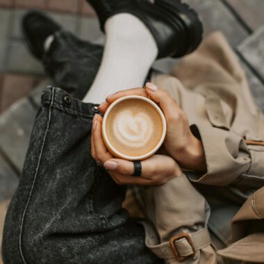 Person Holding a Cup of Cappuccino